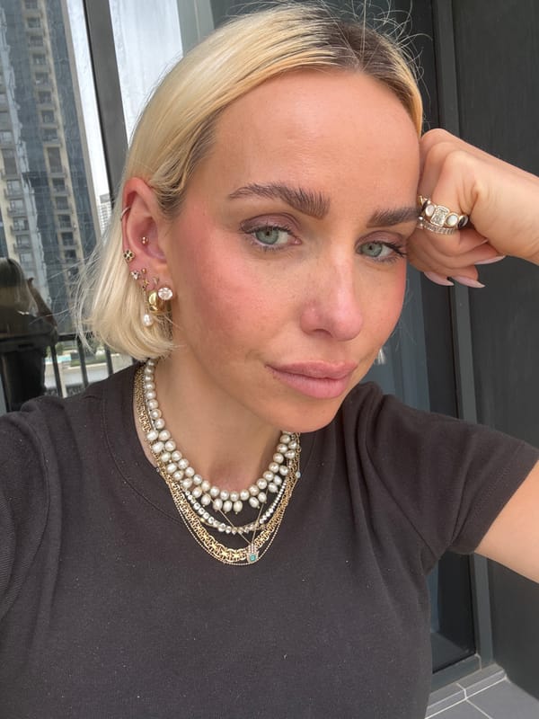 Woman displays elaborate jewelry collection during Dubai photo session