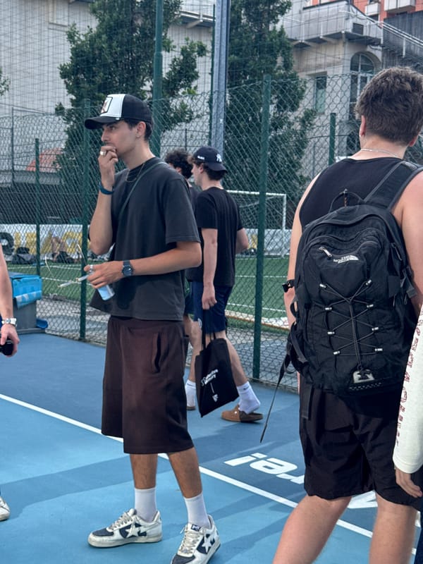 Young men play pickup basketball in Milan afternoon