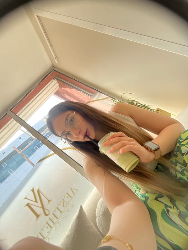 Woman enjoys matcha latte indoors during morning hours