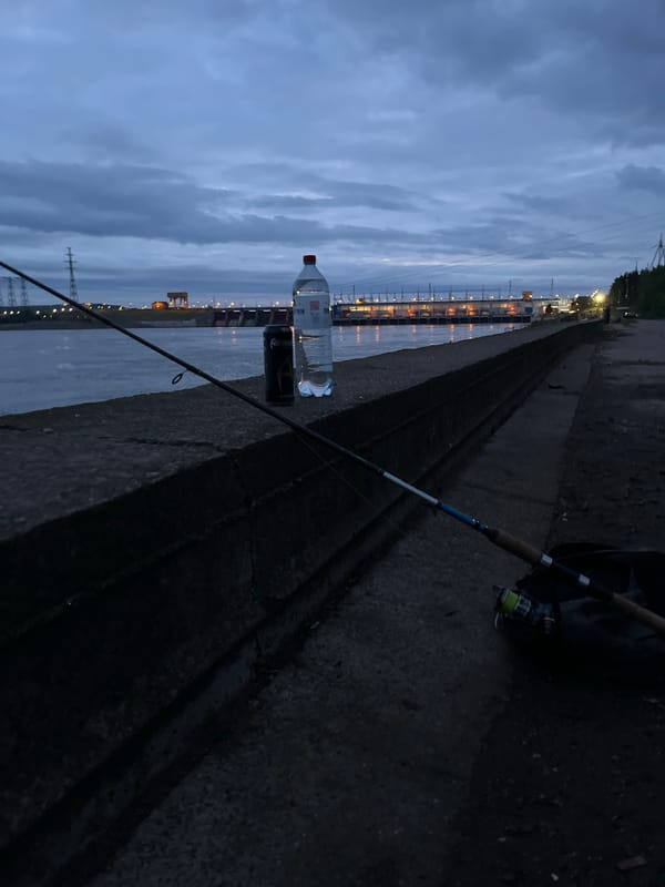 Evening fishing session captured along industrial waterfront in Noviy