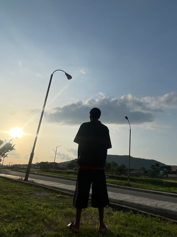 Young man's evening routine captured across Lokoja during sunset
