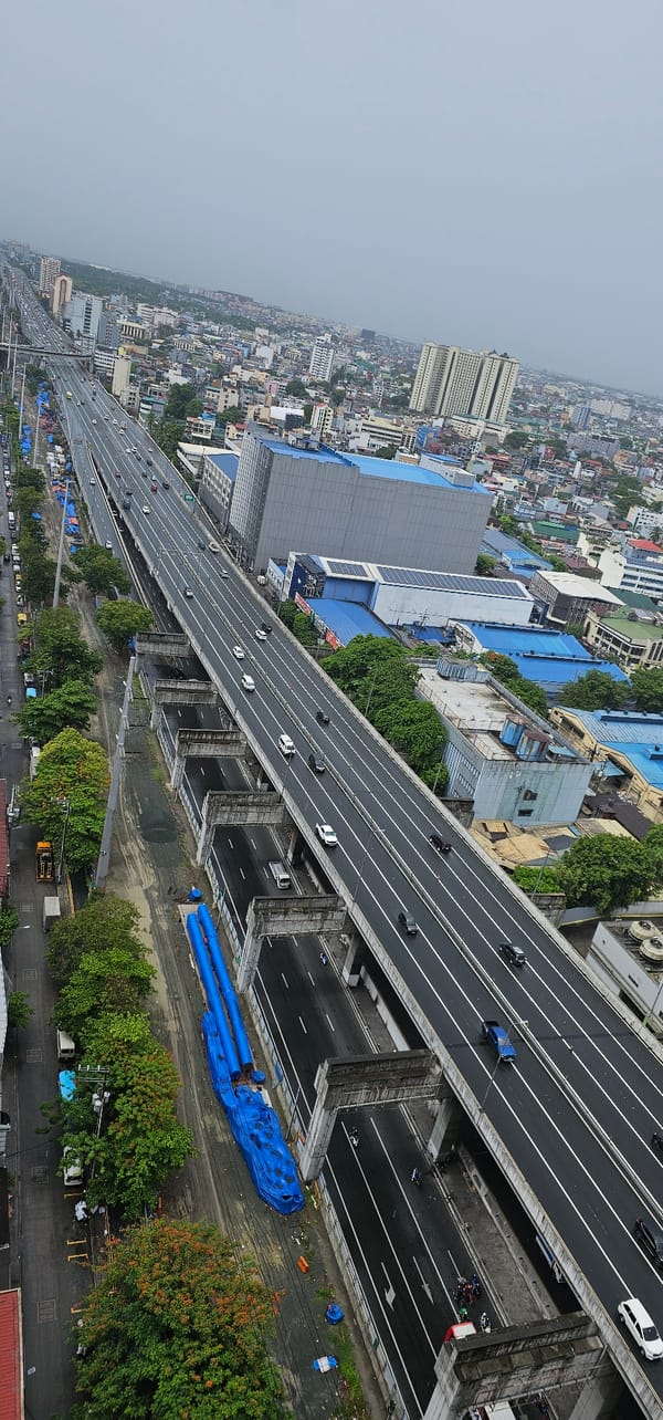 Makati from above: wet highways, busy streets, overcast skyline