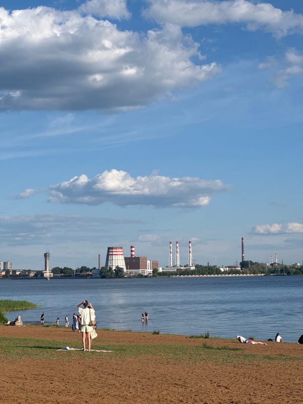 Visitor documents sunny afternoon at Izhevsk waterfront park
