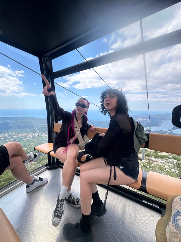 Cable car riders capture scenic Kotor Bay views in Montenegro
