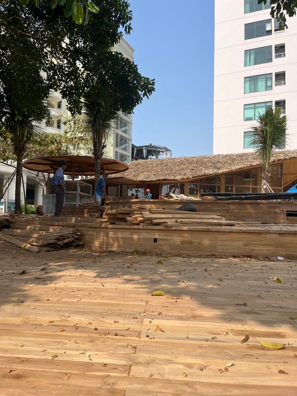 Nighttime construction work continues on wooden structure in Vietnam