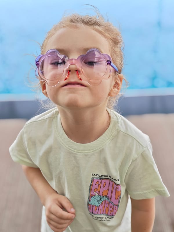 Young girl with flower sunglasses photographed at Mumbai rooftop pool