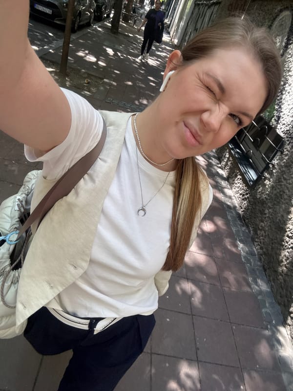 Woman enjoys morning coffee, takes selfies on Belgrade street