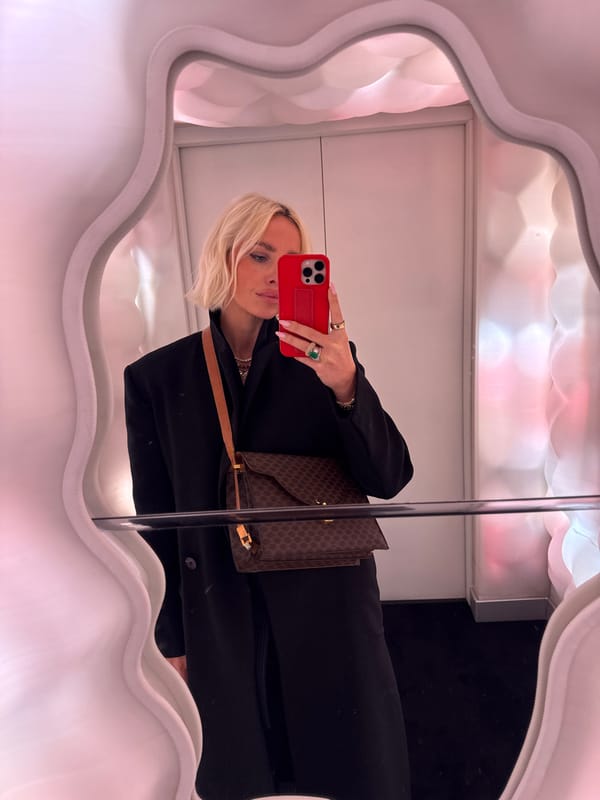 Person takes mirror selfie with red phone