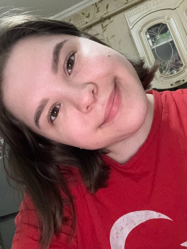 Woman takes selfie in red crescent moon shirt in Kazan