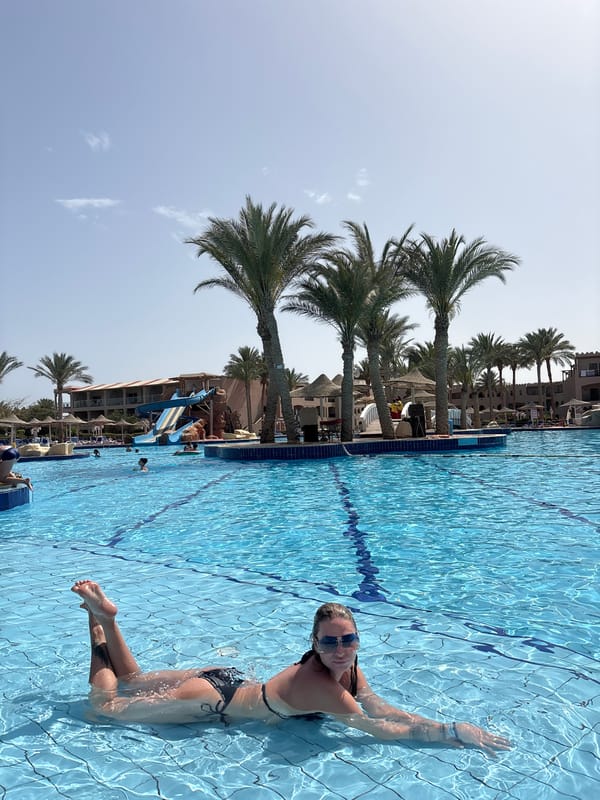 Woman enjoys morning swim at Egyptian resort pool