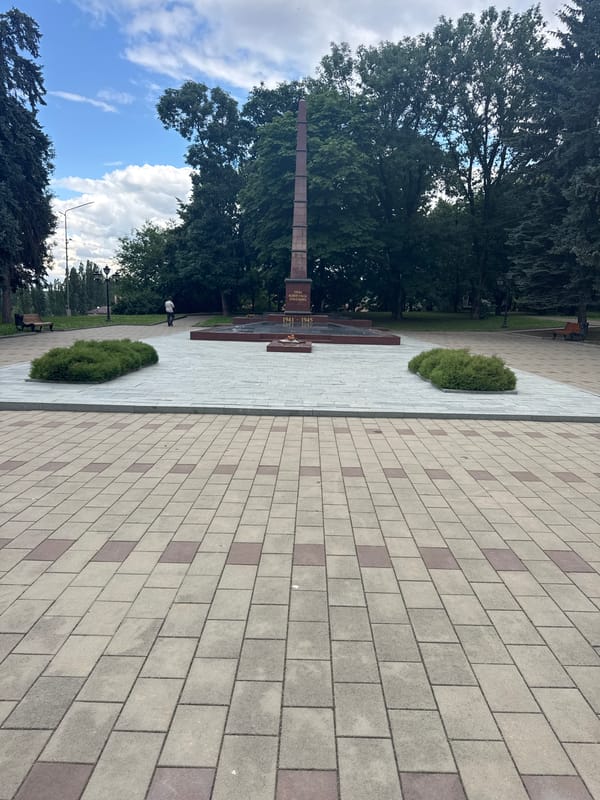 Exploring a formal memorial park with obelisk and monuments