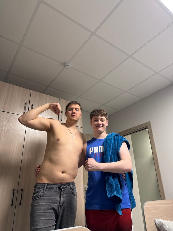 Two men photographed in Kazan gym locker room