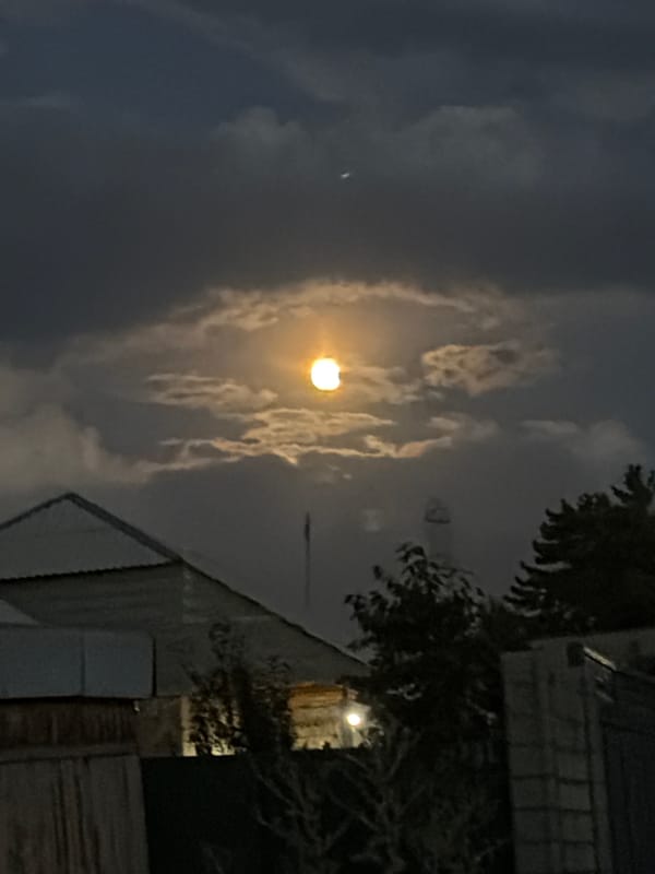 Full moon glows orange through clouds over Ak-Ordo 3