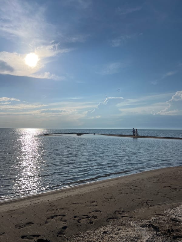 Calm lakeshore beach in Kyrgyzstan, drone resting on dark sand