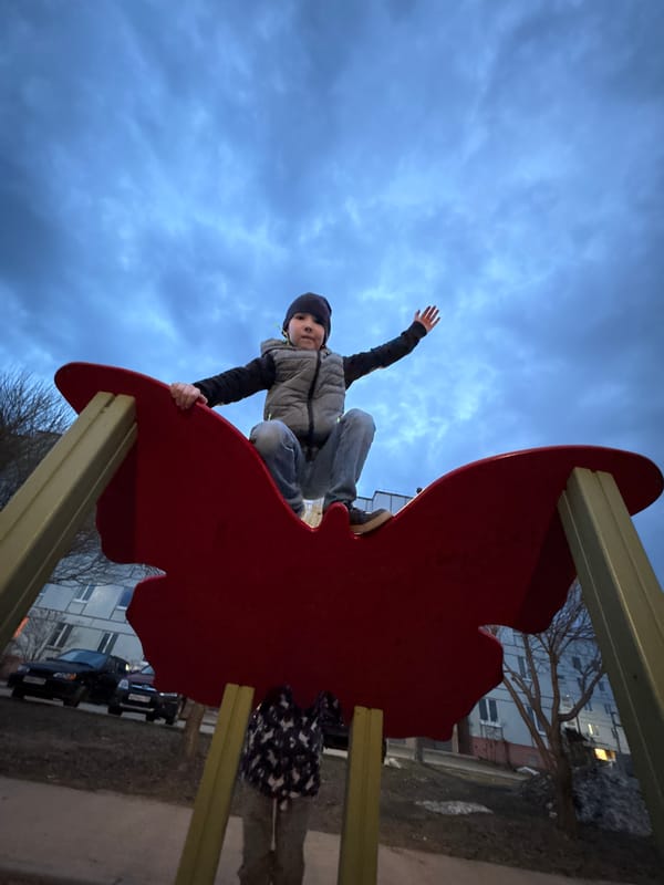 Family enjoys playground time in Chaikovsky during twilight hours