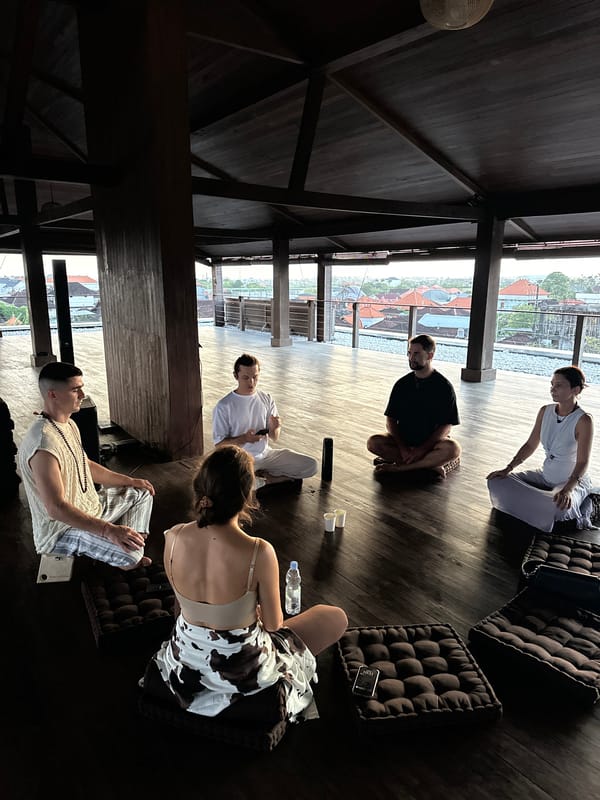 Group holds meditation session in wooden pavilion in Mengwi