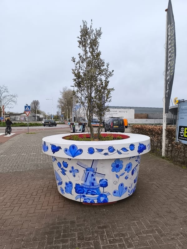 Decorative planters spotted on Alkmaar street display contrasting artistic styles