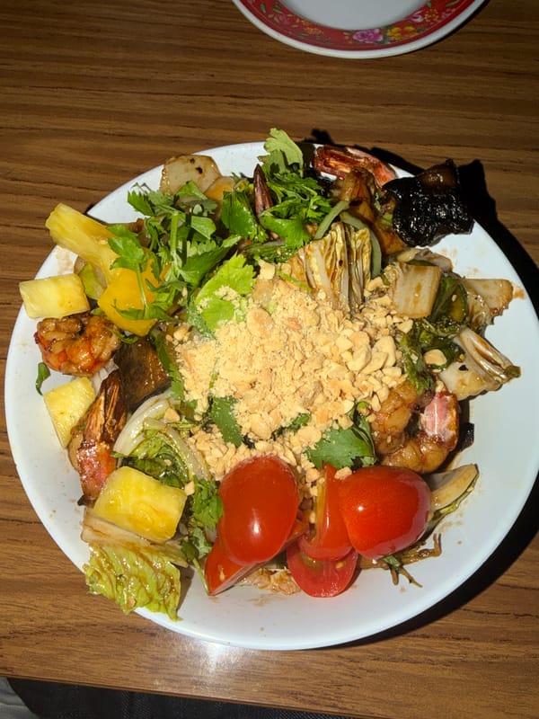 Shrimp salad meal documented on wooden table in Buenos Aires