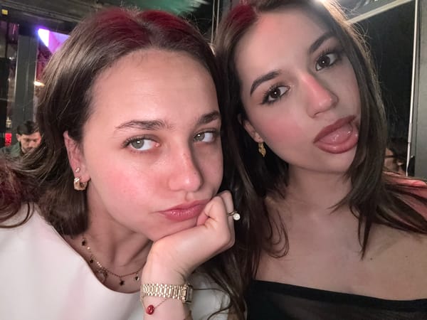 Two women take selfie at Milan bar table
