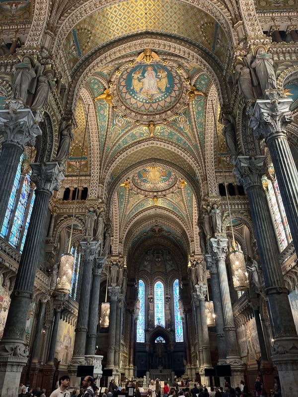 Visitor documents ornate interiors at Lyon's Notre-Dame de Fourvière basilica