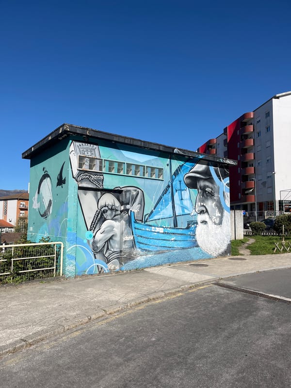 Building mural featuring elderly pipe smoker spotted in Vila Real