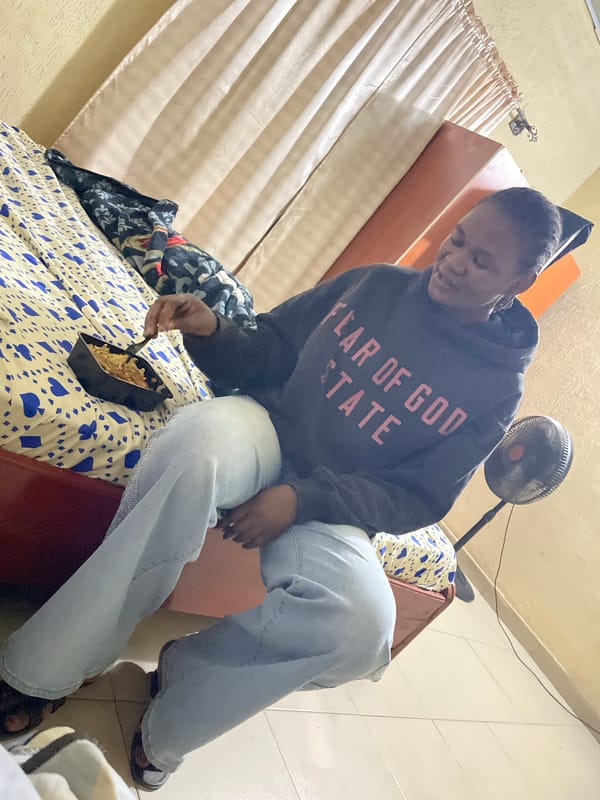 Person eating from container on bed in Jos