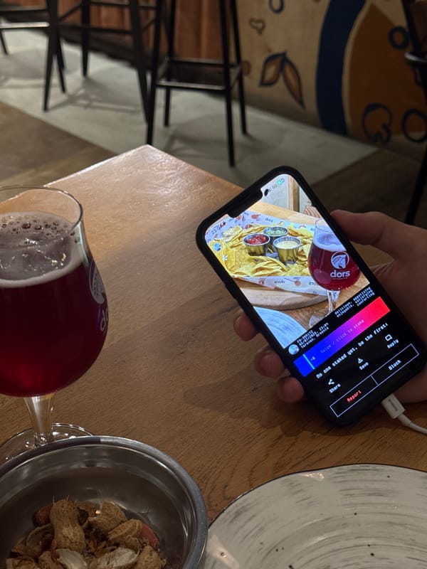 Diner photographs nachos and beer meal in Yerevan restaurant