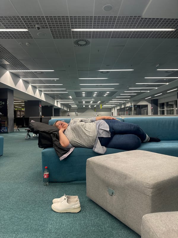 Person rests on sofa in modern building