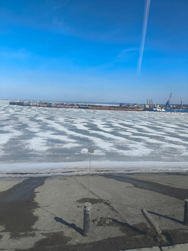 Ship docked at frozen harbor in Chaikovsky, Russia