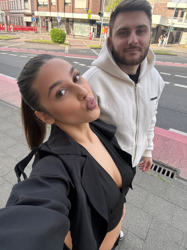 Couple photographs themselves near graffiti wall in Mönchengladbach