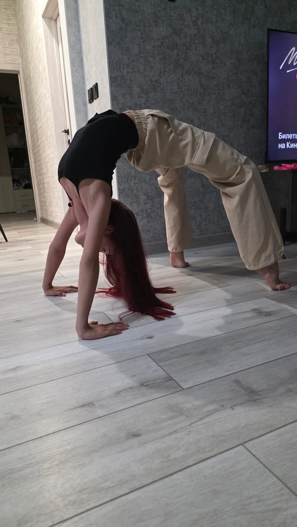 Woman practices yoga poses in Bulgakovo home