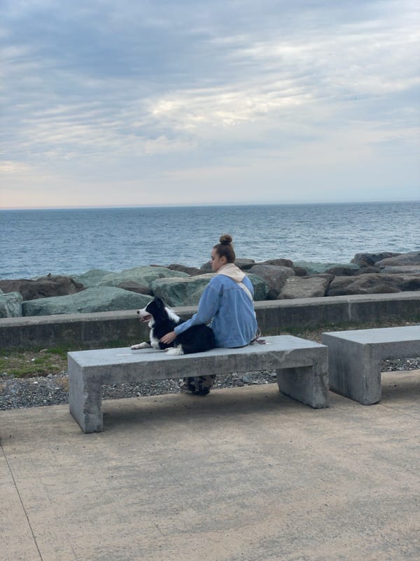 Woman relaxes with dog on Batumi coastline