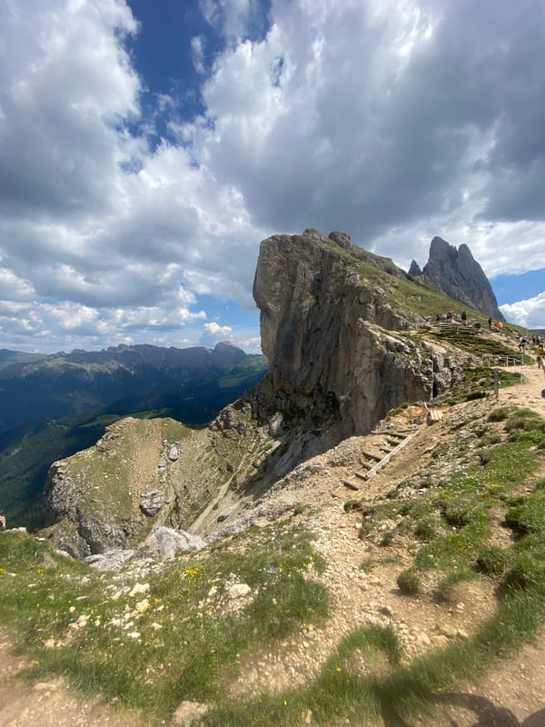 Morning hike through the Dolomites, cliffs and wildflower meadows