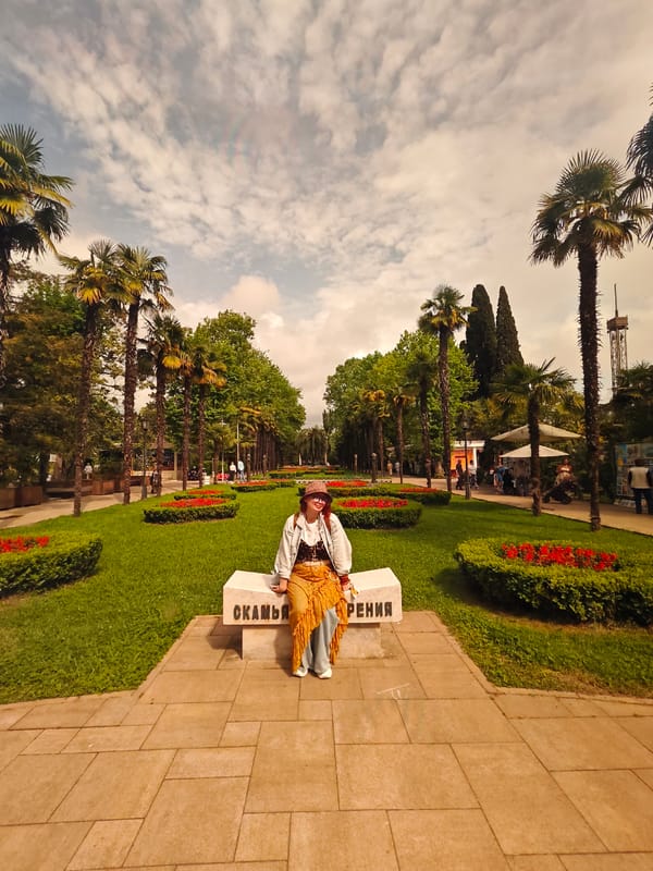 Woman enjoys leisurely park visit near fountain in Sochi