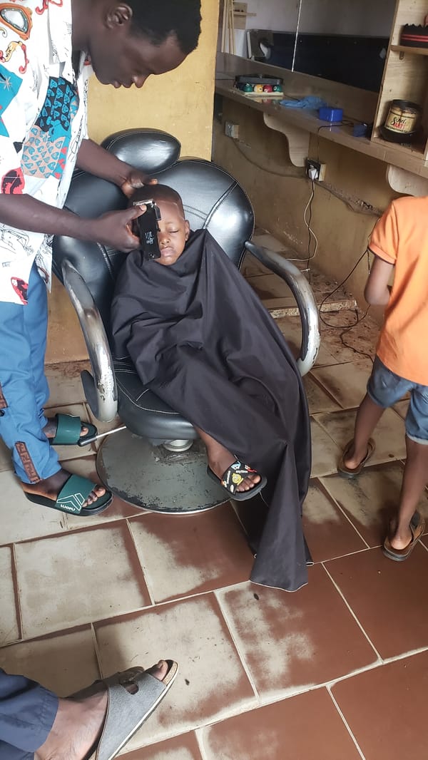 Child gets haircut at Narayi barbershop