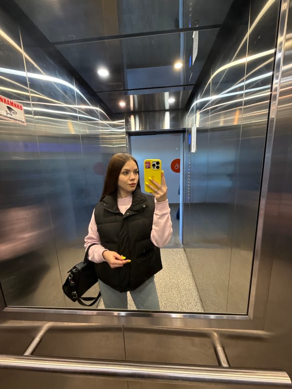 Person Takes Selfie in Mirrored Elevator in Yekaterinburg