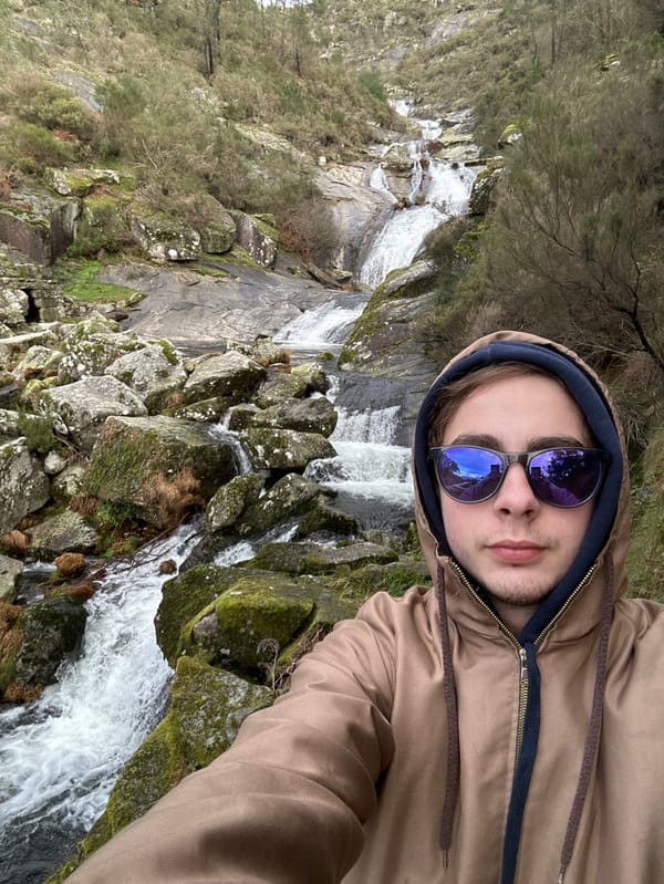 Tourist takes selfies at waterfall in northern Portugal