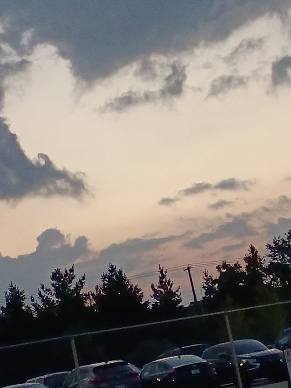 Dusk settles over a fenced parking lot in Lexington