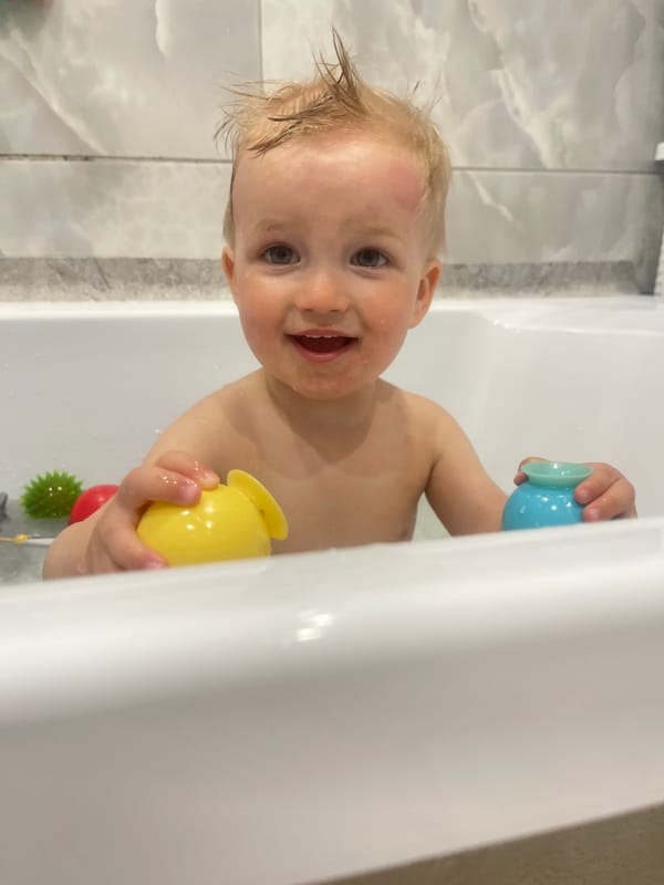 Child enjoys bath time with toys in Izhevsk home