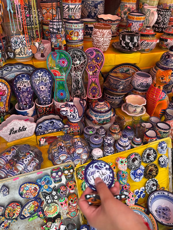 Talavera ceramics vendor displays wares at Puebla marketplace