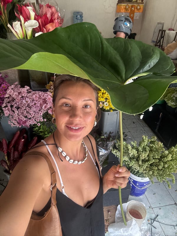 Woman arranges tropical bouquets at North Kuta flower shop