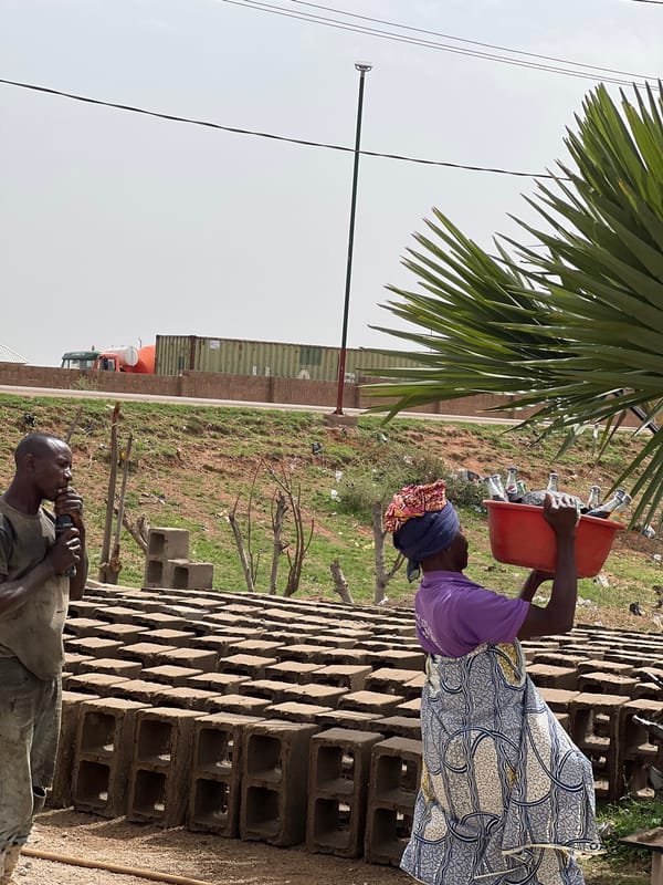 Woman carries bucket in Du, Nigeria