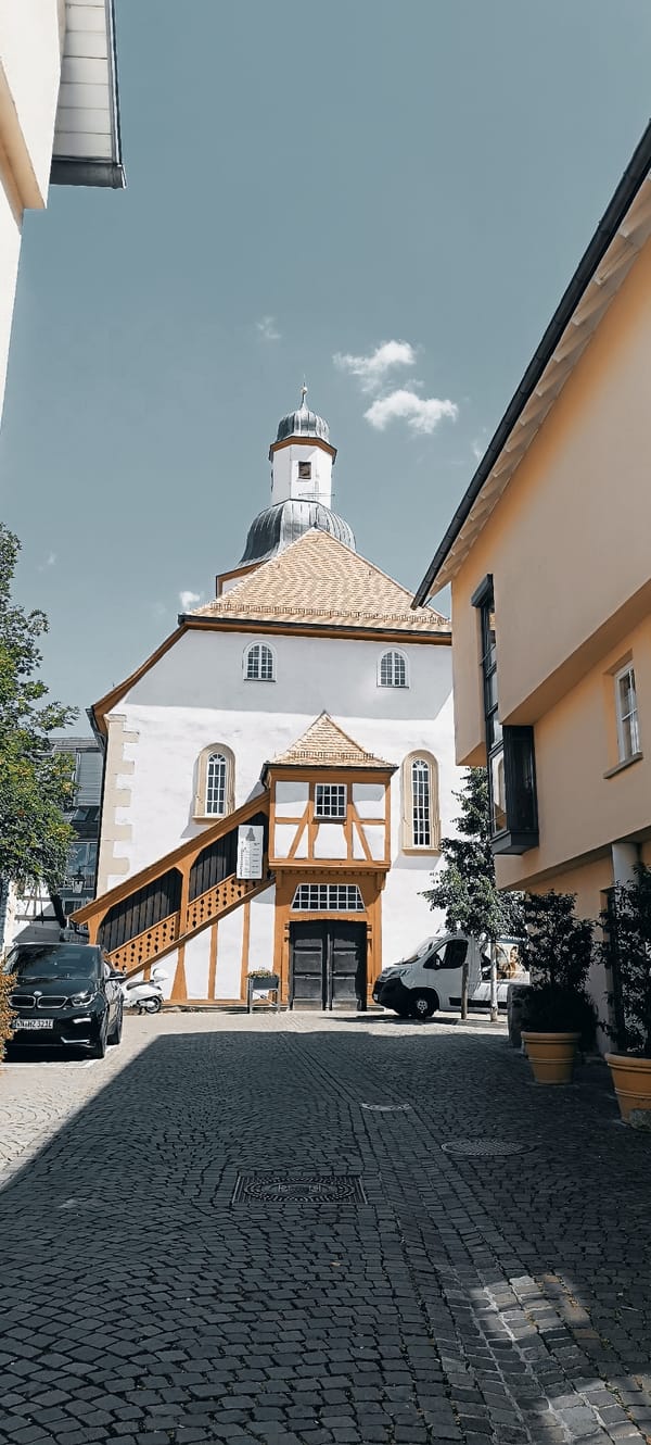 Cobblestone streets and a domed church in a European old town