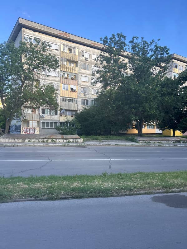 Worn apartment building with graffiti observed in Ruse, Bulgaria