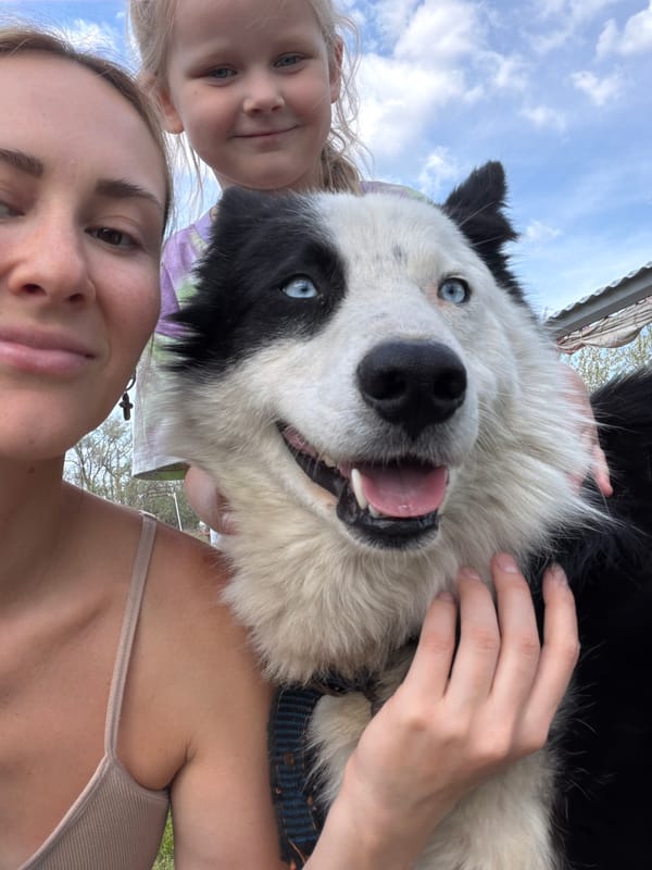 Mother, daughter pose with blue-eyed dog in Kamyshin