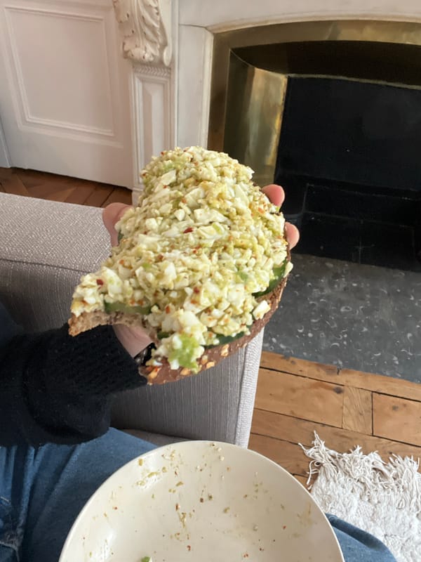Person holds egg salad sandwich in Lyon, France