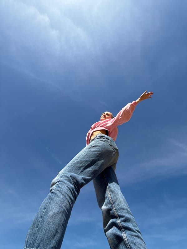 Person waves against blue sky in Chaykovsky, Russia