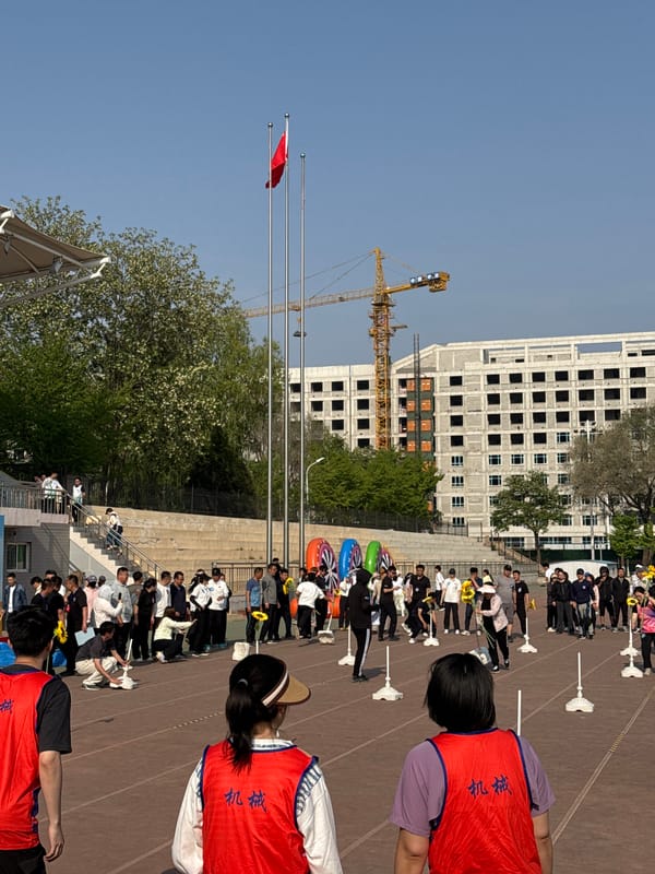 Group holds sunflowers during outdoor activities at Zhongtun track facility