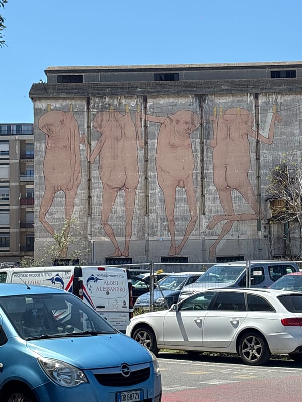 Brutalist building with nude figure mural observed in Messina