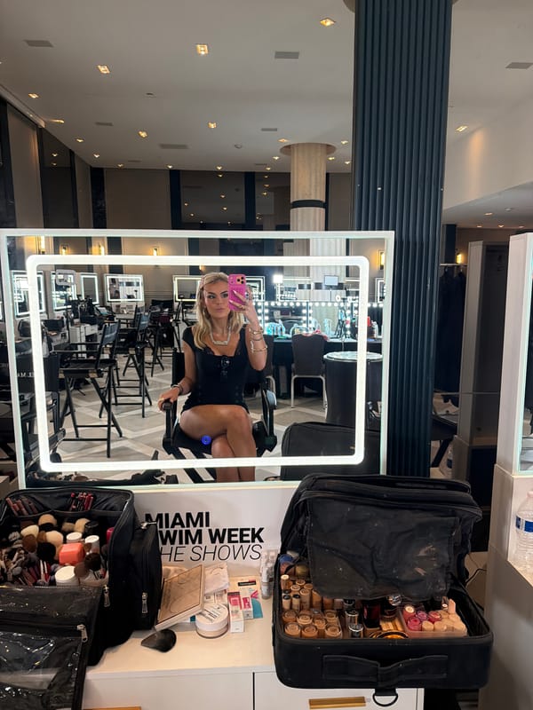 Woman takes selfies at Miami Swim Week makeup station